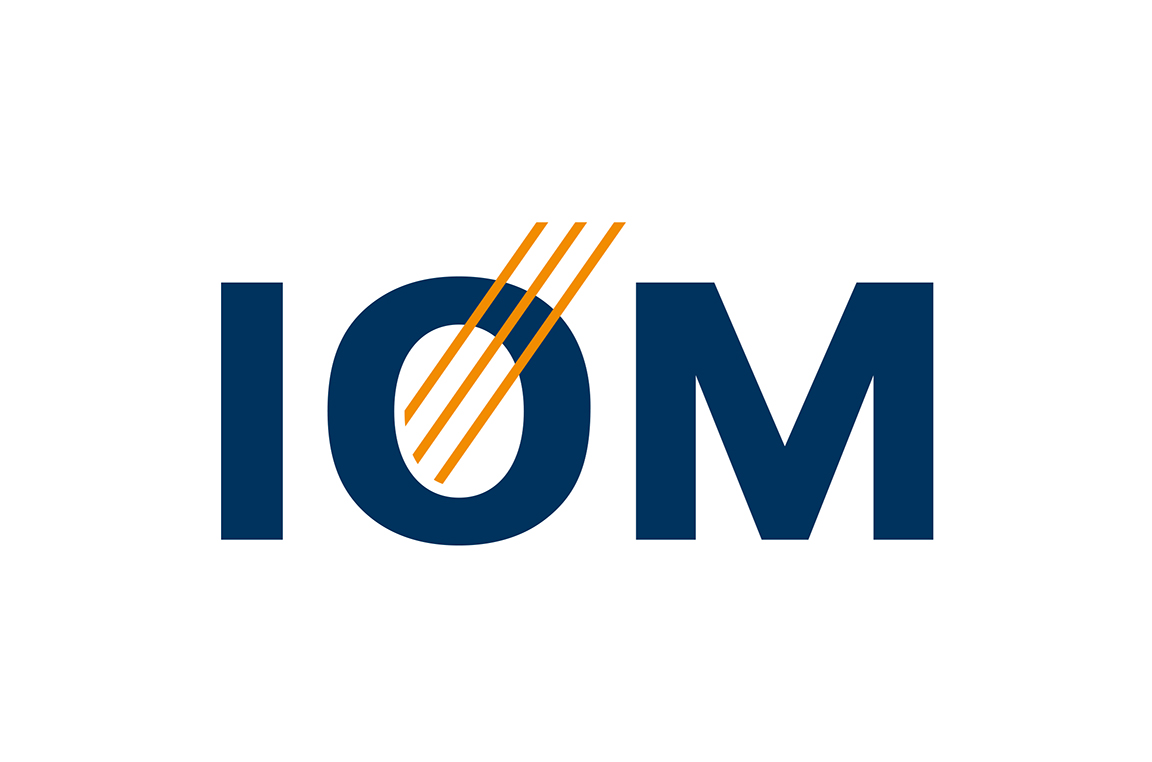 Logo des IOM mit dunkelblauen Buchstaben „IOM“ und vier orangefarbenen diagonalen Linien durch das „O“ in klarem, modernem Design.